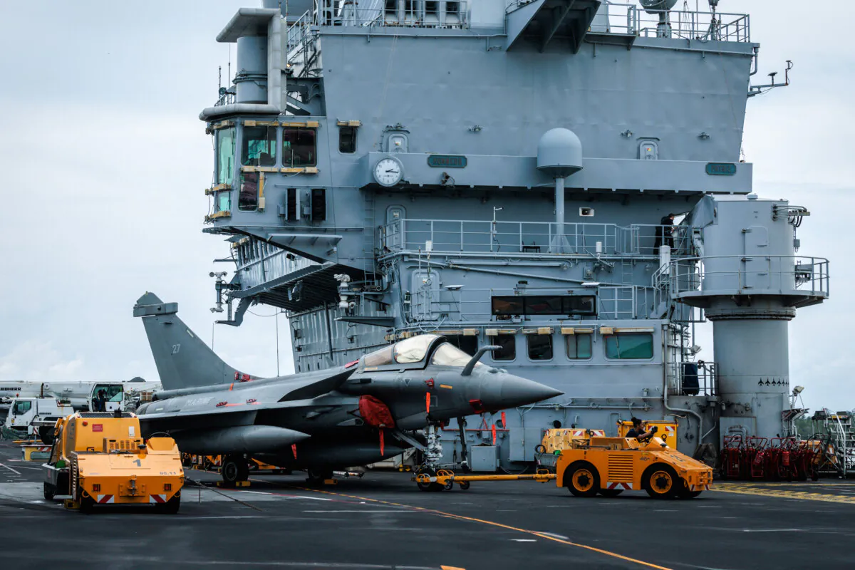 A Rafale jet fighter is towed on the flight deck of the French Navy's nuclear-powered aircraft carrier Charles de Gaulle during its first-ever port call in Indonesia as part of the Clemenceau 25 mission, a four-month deployment covering the Mediterranean and Indo-Pacific regions to enhance cooperation with allied navies, at Lombok Island, east of Bali, on Jan. 28, 2025. (Yasuyoshi Chiba/AFP via Getty Images)