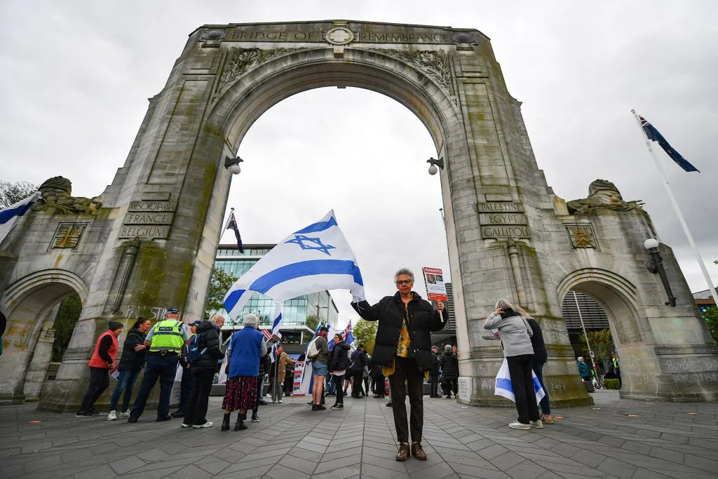 A participant holds a placard and Israel national flag during a pro-Israel rally in Christchurch, New Zealand, on Oct. 22, 2023. (Sanka Vidanagama/AFP via Getty Images)