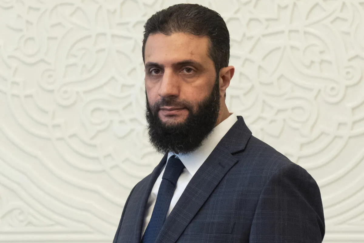 Syria's de facto leader Ahmad al-Sharaa, formerly known as Abu Mohammed al-Golani, walks in the presidential palace ahead of his meeting with Walid Ellafi, Libyan minister of state for communication and political affairs, in Damascus, Syria, on Dec. 28, 2024. (Mosa'ab Elshamy/AP Photo)