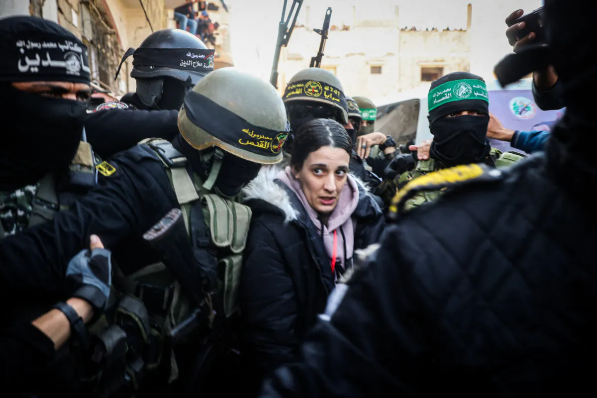Islamic Jihad and Hamas terrorists escort Israeli hostage Arbel Yehud to hand her over to a Red Cross team in Khan Yunis on Jan. 30, 2025, as part of their third hostage-prisoner exchange. (Eyad Baba/AFP via Getty Images)