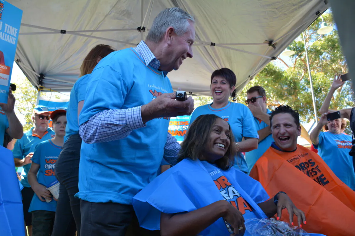WA Premier Colin Barnett shaves a woman's head at the World's Greatest Shave event in Midland on March 5, 2017. (AAP Image/Rebecca Le May)