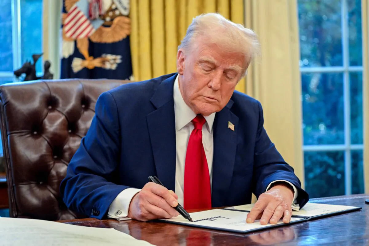 U.S. President Donald Trump signs an executive order in the Oval Office of the White House on Jan. 30, 2025 in Washington. (Photo by ROBERTO SCHMIDT / AFP) (Photo by ROBERTO SCHMIDT/AFP via Getty Images)