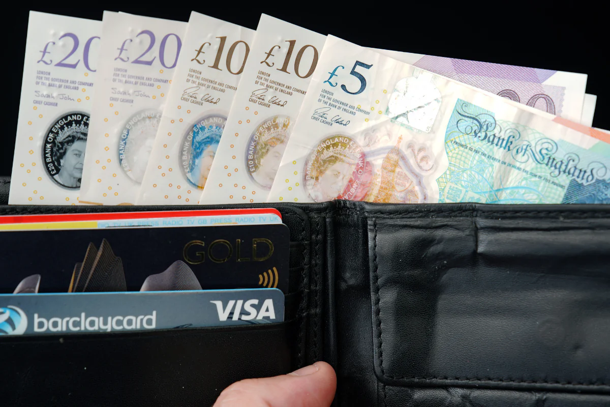 File photo of £5, £10, £20 notes, and credit cards, dated June 23, 2023. (Peter Byrne/PA Wire)