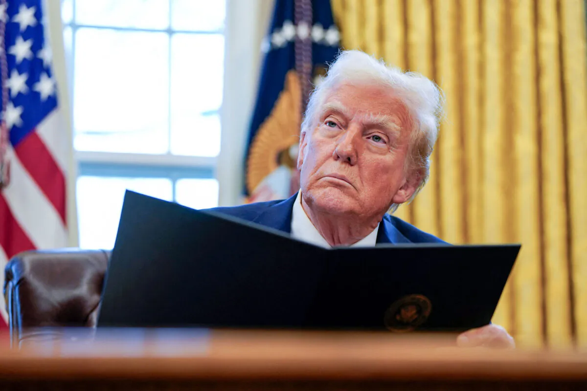 President Donald Trump signs executive orders in the Oval Office at the White House on Jan. 30, 2025. (Elizabeth Frantz/Reuters)