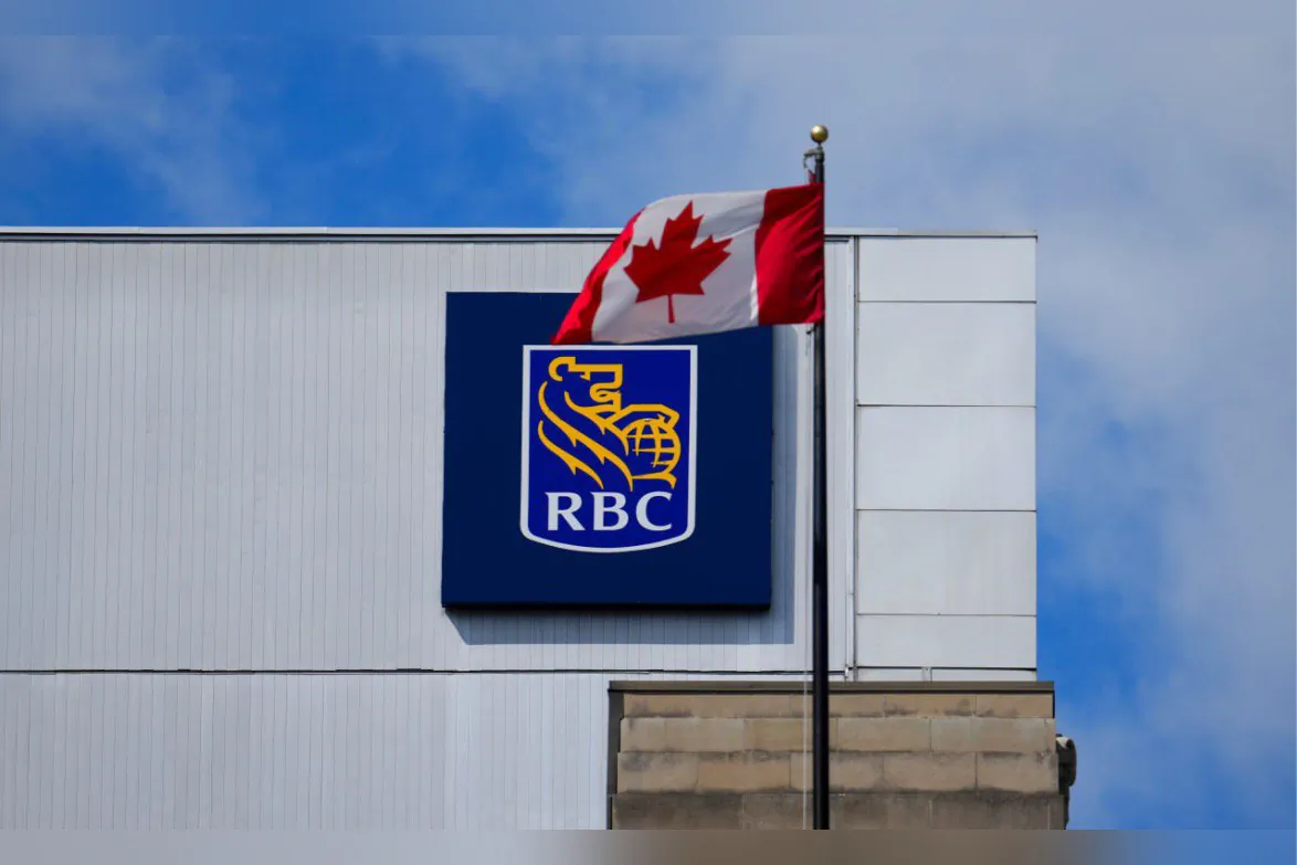 A Royal Bank of Canada sign and a Canada flag are pictured in Ottawa on June 27, 2024. (The Canadian Press/Sean Kilpatrick)