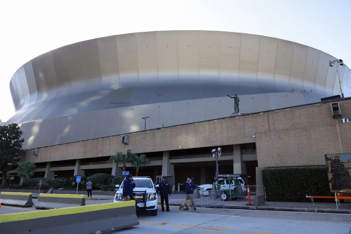 Security and bomb sniffing dogs check vehicles as they enter the Superdome parking garage ahead of the Sugar Bowl NCAA College Football Playoff game in New Orleans on Jan. 2, 2025. (Butch Dill/AP Photo)