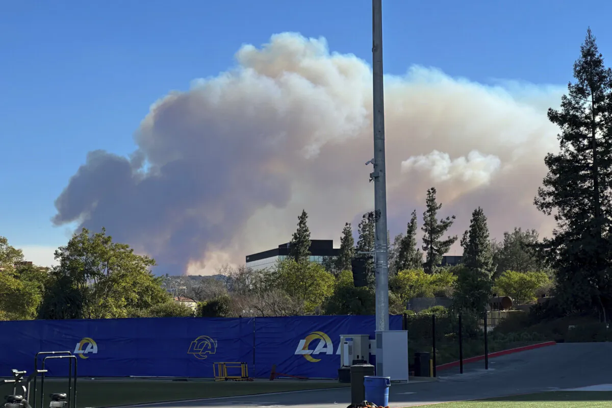 Smoke from a wildfire rises over the Los Angeles Rams practice facility in the Woodland Hills section of Los Angeles on Jan. 9, 2025. (Greg Beacham/AP Photo)