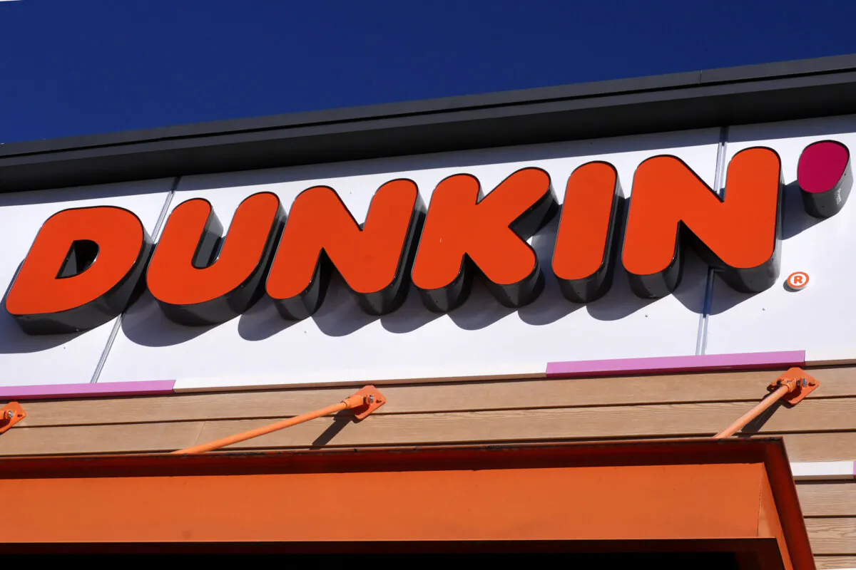 The Dunkin' name appears on a sign over the doorway at a Dunkin' donuts location, Jan. 10, 2025, in Derry, N.H. (AP Photo/Charles Krupa)