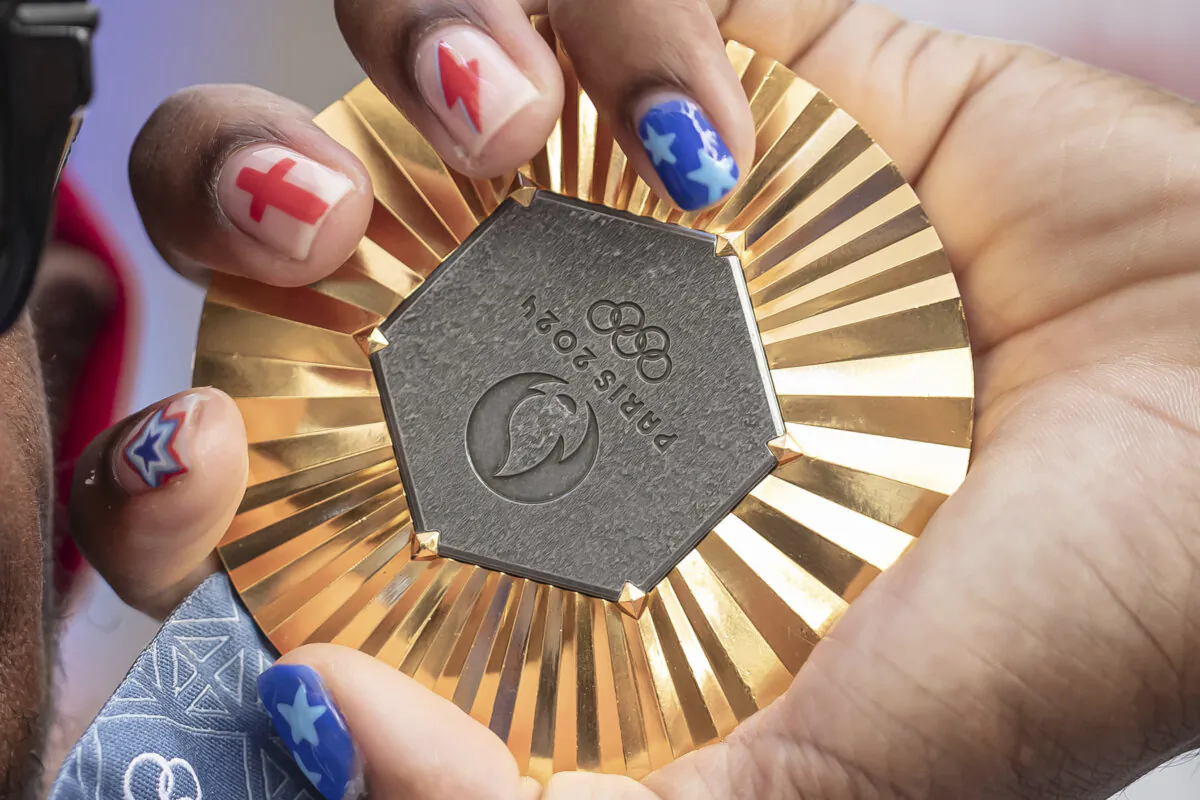 American Olympic champion Noah Lyles holds this gold medal before an interview in Paris, France, on Aug. 11, 2024. (Aurelien Morissard/AP Photo)