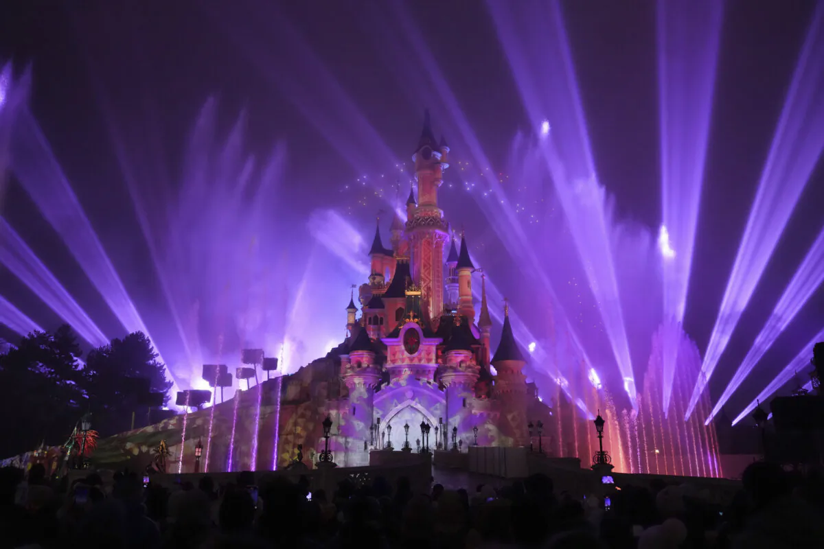 A light show is projected on the castle of Sleeping Beauty as fireworks explode in Disneyland, in Marne-la-Vallee, east of Paris, on Jan. 17, 2025. (Thibault Camus/AP Photo)