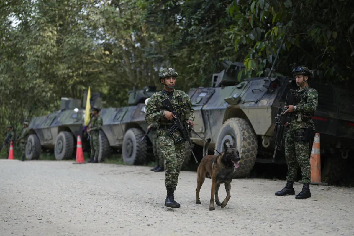 Soldiers patrol a road in Tibu in Colombia's northeastern Catatumbo region, Monday, Jan. 20, 2025, where dozens have been killed amid clashes between the National Liberation Army (ELN) and former members of the Revolutionary Armed Forces of Colombia (FARC). (Fernando Vergara/AP Photo)
