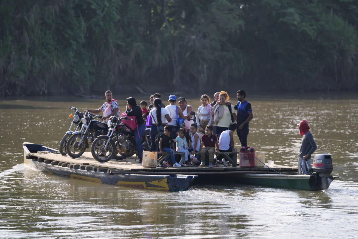 Residents cross a river to Venezuela from Colombia's Tibu on Jan. 21, 2025. (Fernando Vergara/AP Photo)