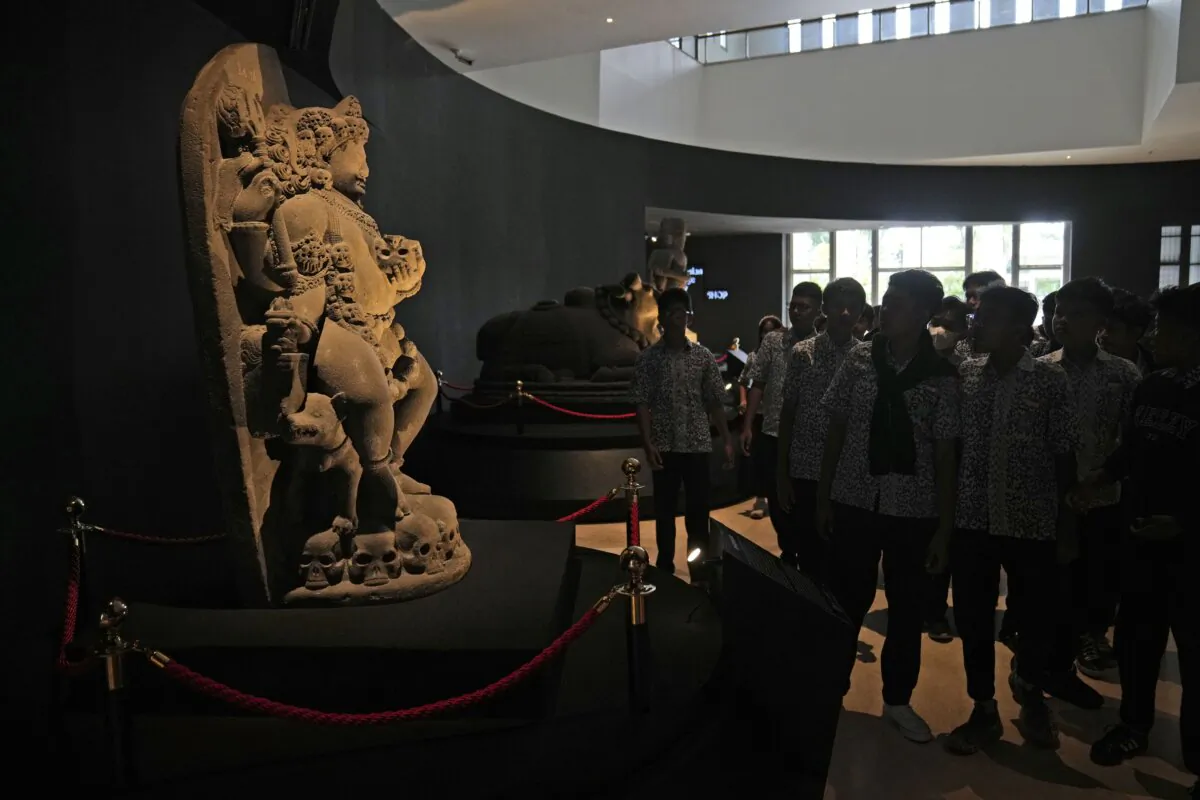 A group of students examine the statue of Hindu deity Bhairava which is a part of Indonesian historical artifacts repatriated from the Netherlands, at the National Museum in Jakarta, Indonesia, on Jan. 8, 2025. (Dita Alangkara/AP Photo)