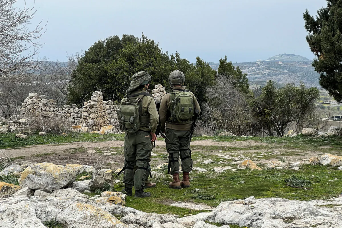 Israeli soldiers look out, after a ceasefire between Israel and Hezbollah took effect, near Israel's border with Lebanon, in northern Israel on Jan. 26, 2025. (Avi Ohayon/Reuters)