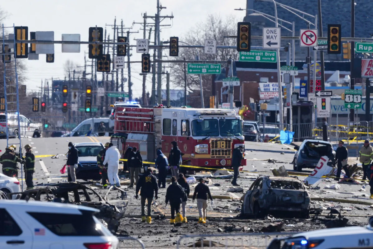 Investigators work the scene where a small plane crashed in Philadelphia, on Feb. 1, 2025. (Matt Rourke /AP Photo)