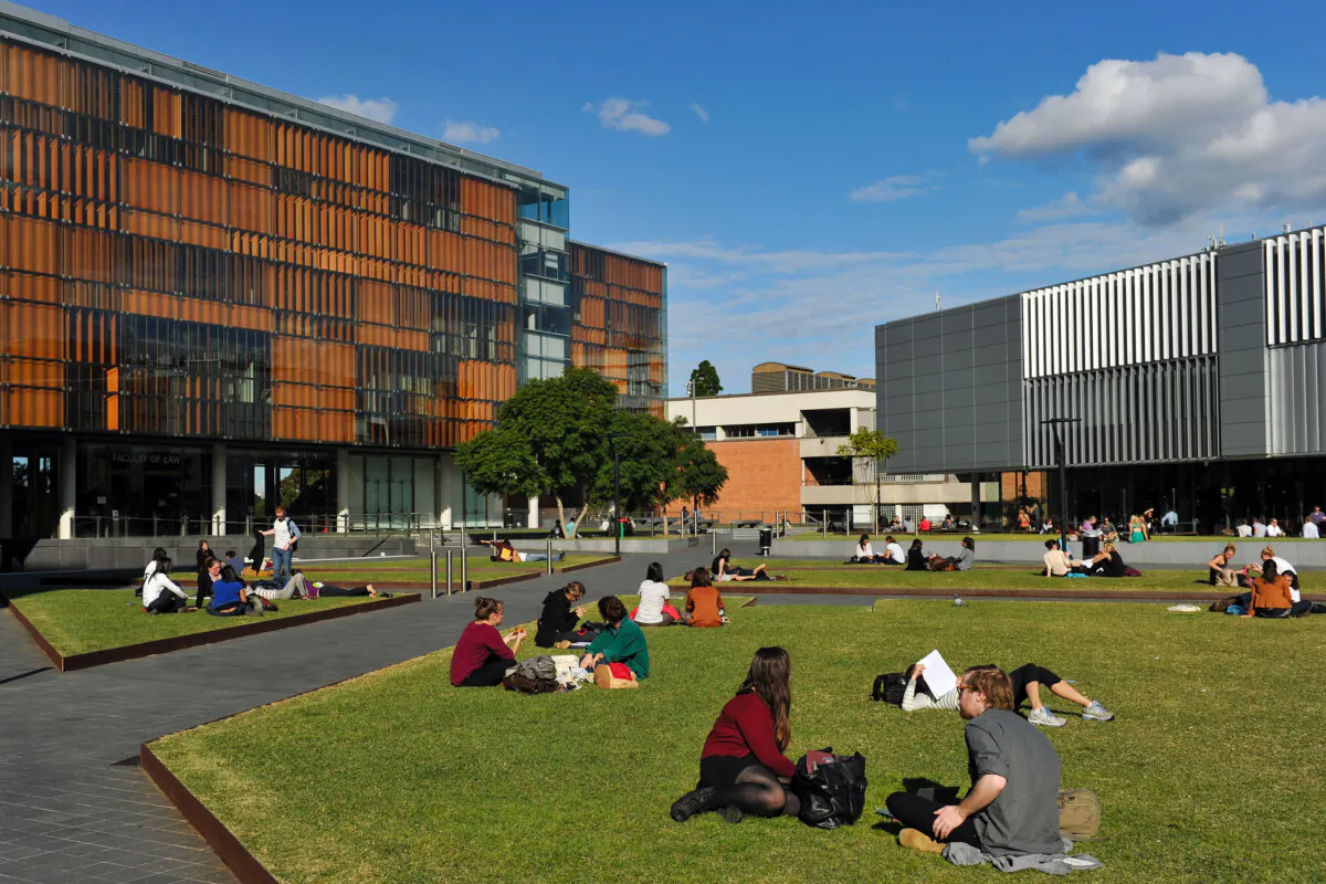 Students sit on the lawn near the Faculty of Law building at The University of Sydney, in Sydney, Australia, on May 8, 2013. (AAP Image/Paul Miller) 