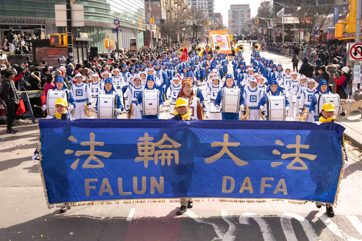 Falun Gong practitioners take part in the Chinese New Year parade in the Flushing neighborhood of Queens, N.Y., on Feb. 1, 2025, as members of the  Tianguo Marching Band. (Larry Dye/The Epoch Times)