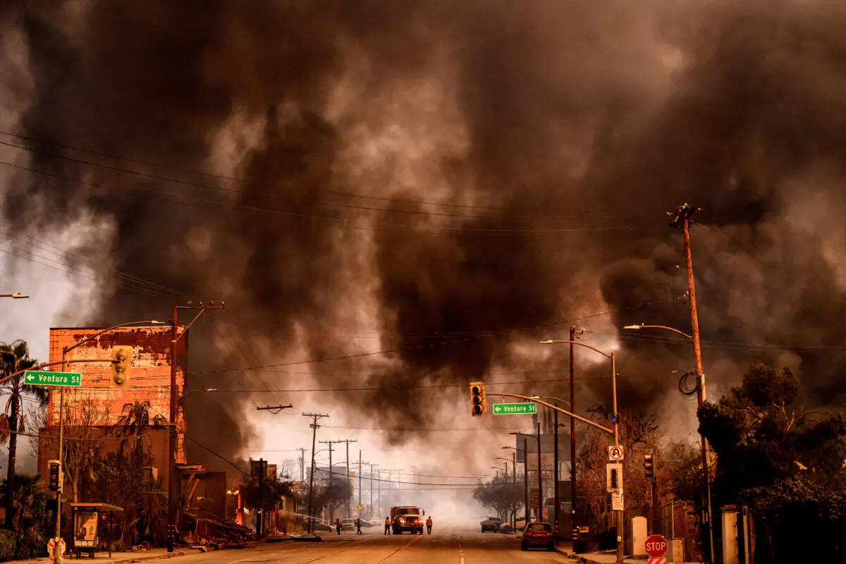 Smoke and flames overwhelm a commercial area during the Eaton Fire in the Altadena area of Los Angeles County, Calif., on Jan. 8, 2025. (Josh Edelson/AFP via Getty Images)