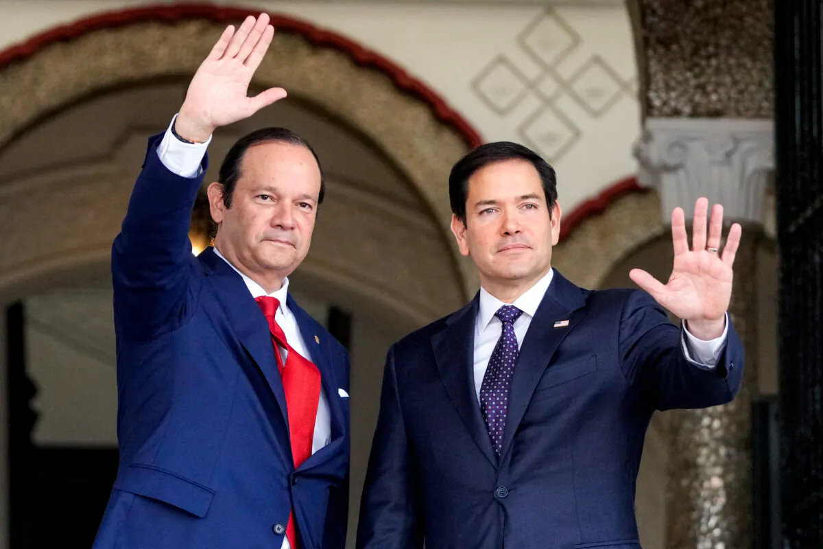 Panamanian Foreign Minister Javier Martínez-Acha (L) and U.S. Secretary of State Marco Rubio wave on arrival for a meeting with Panamanian President José Raúl Mulino at the presidential palace in Panama City on Feb. 2, 2025. (Mark Schiefelbein/Pool/AFP via Getty Images)