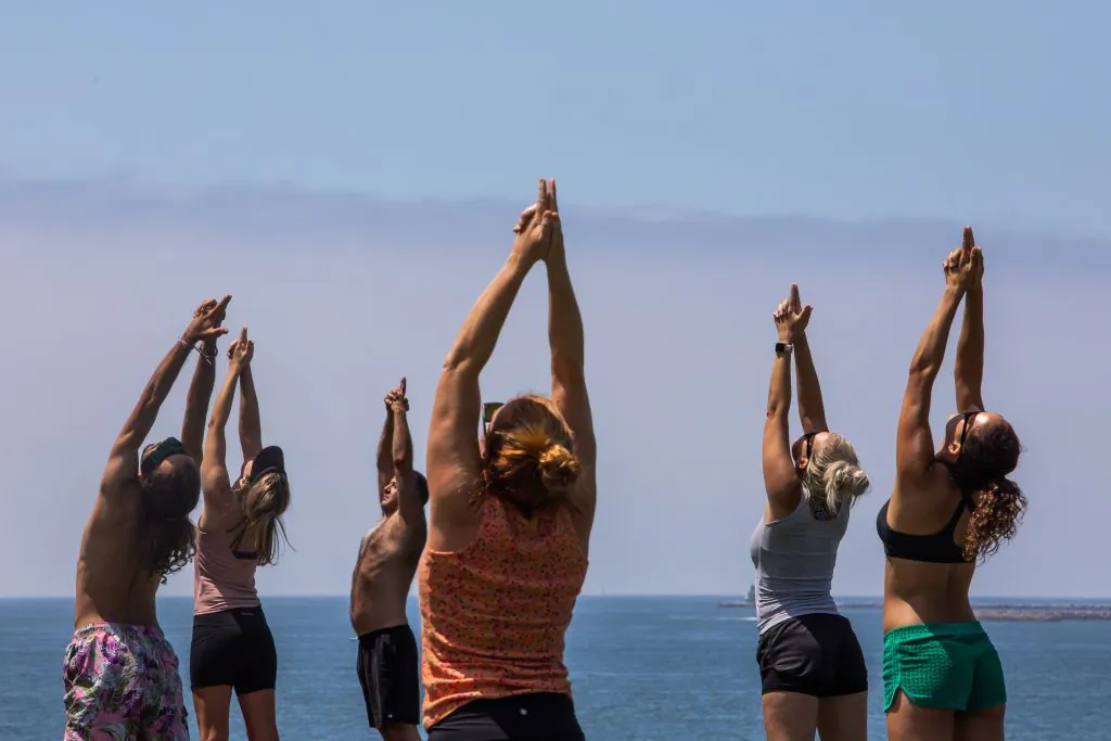 People practice yoga at Bluff park in Long Beach, Calif., on July 14, 2020. (Apu Gomes/AFP via Getty Images)