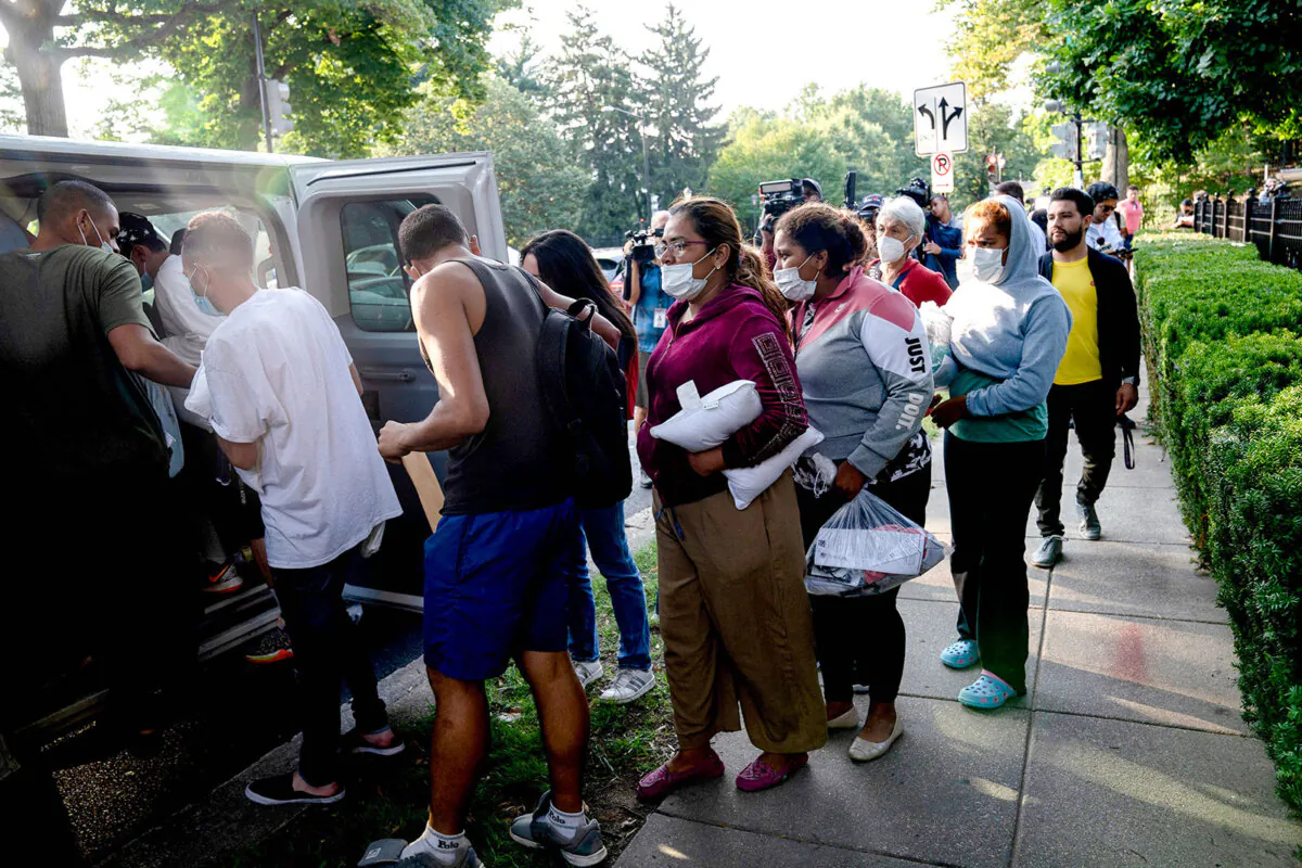 Illegal immigrants from Venezuela, who boarded a bus in Texas, wait to be transported to a local church by volunteers after being dropped off outside the residence of Vice President Kamala Harris, at the Naval Observatory in Washington on Sept. 15, 2022. (Stefani Reynolds/AFP via Getty Images)