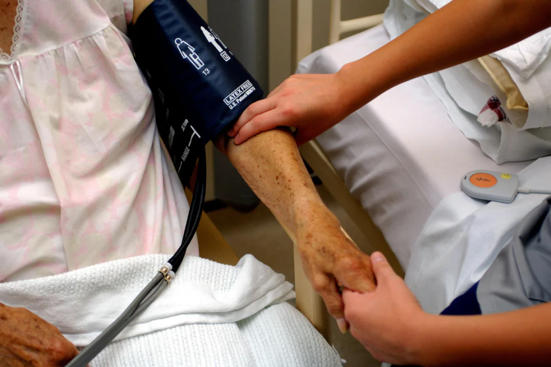 A nurse taking the blood pressure of an older person at an NHS hospital in England on Jan 18, 2023. (PA/PA Wire)