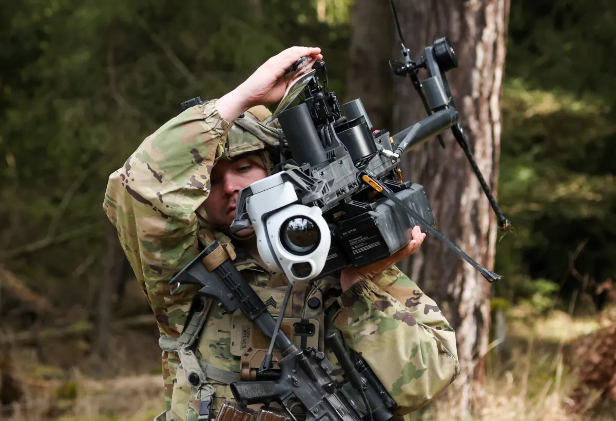 A soldier of a Lethal Unmanned Aircraft System platoon of the U.S. Army 3rd Brigade, 10th Mountain Division, carries a Ghost-X helicopter surveillance drone during the Combined Resolve 25-1 military exercises at the Hohenfels Training Area in Bavaria near Hohenfels, Germany, on Feb. 3, 2025. (Sean Gallup/Getty Images)