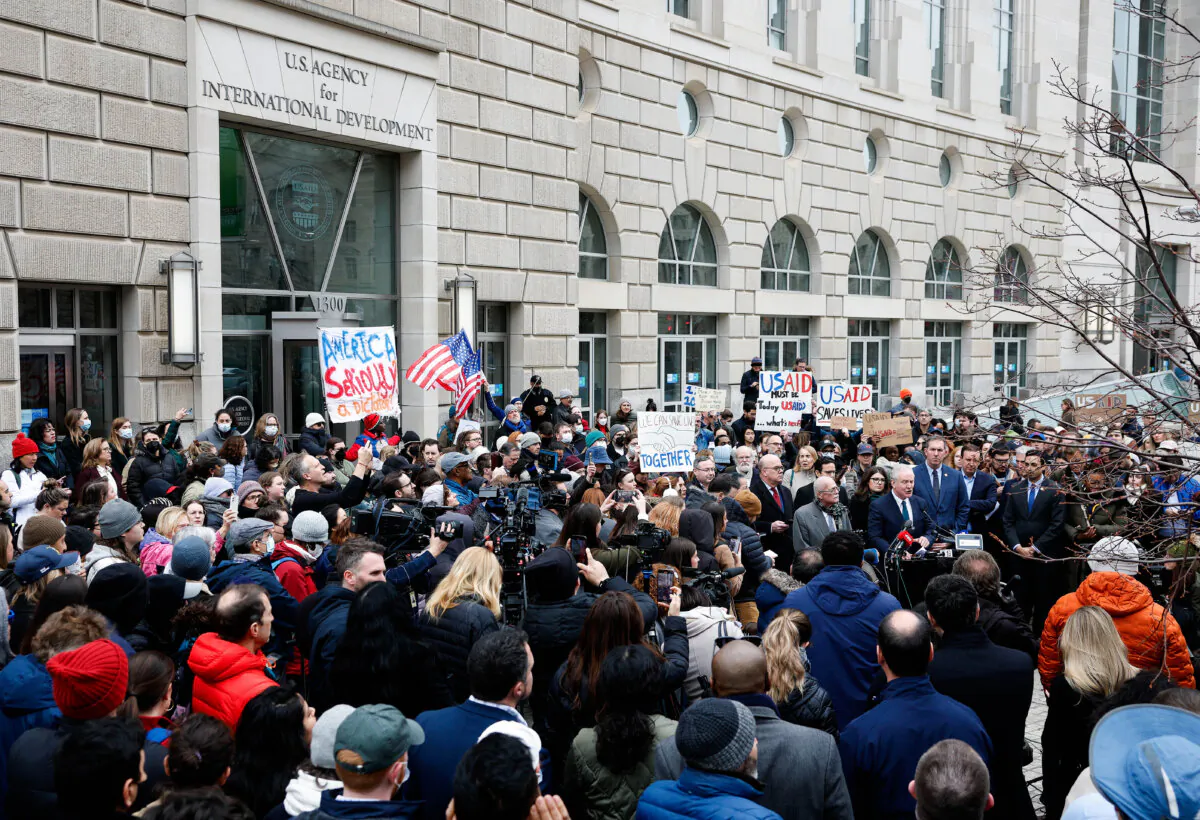 Sen. Chris Van Hollen (D-Md.) and Rep. Gerry Connolly (R-Va.), joined by fellow lawmakers and employees and supporters of U.S. Agency for International Development (USAID), speak at a press conference outside the USAID headquarters in Washington on Feb. 3, 2025. (Kevin Dietsch/Getty Images)