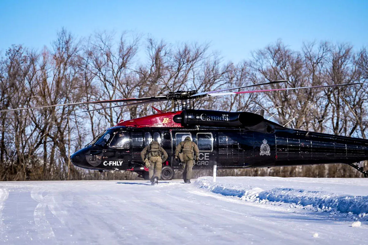 RCMP officers approach one of the force's newly acquired Blackhawk helicopters for patrolling the Canada–U.S. border. (RCMP handout)