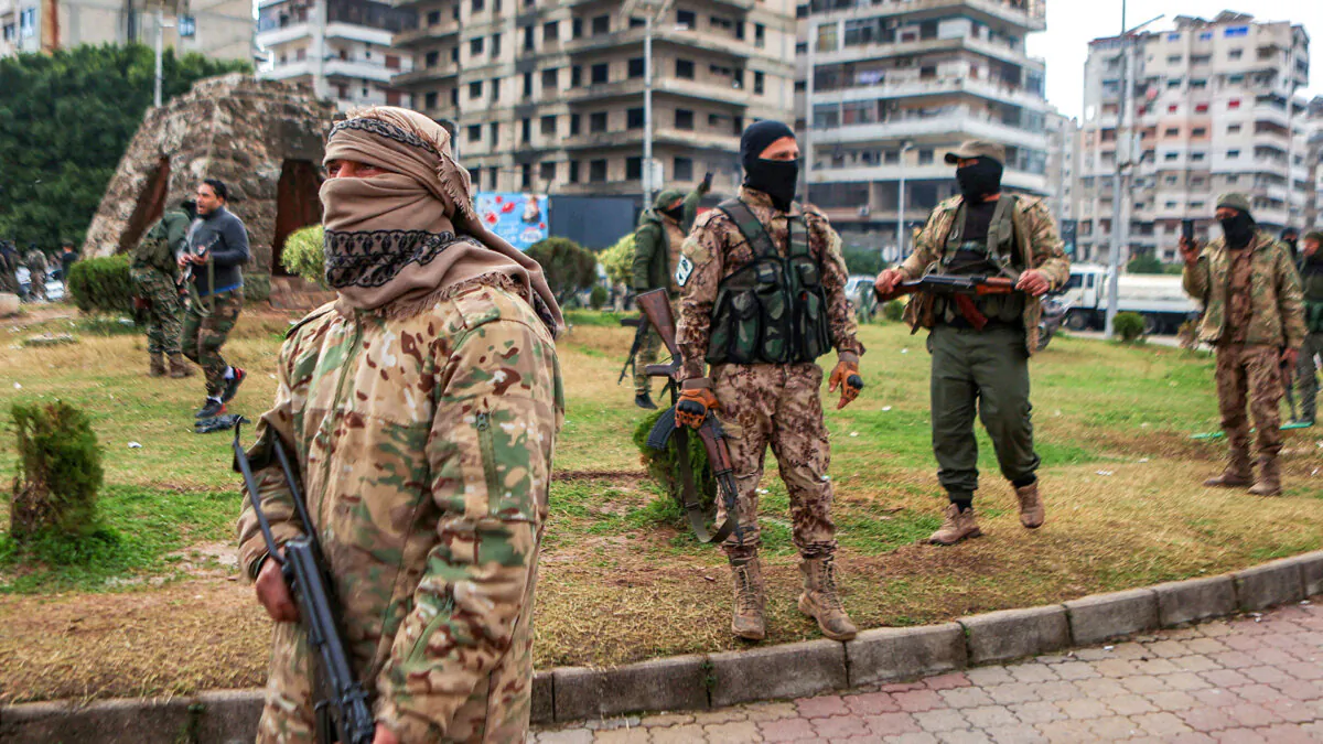 Fighters affiliated with Syria's new regime stand guard on the streets of the western coastal city of Latakia, Syria, on Dec. 26, 2024. (Aaref Watad/AFP via Getty Images)