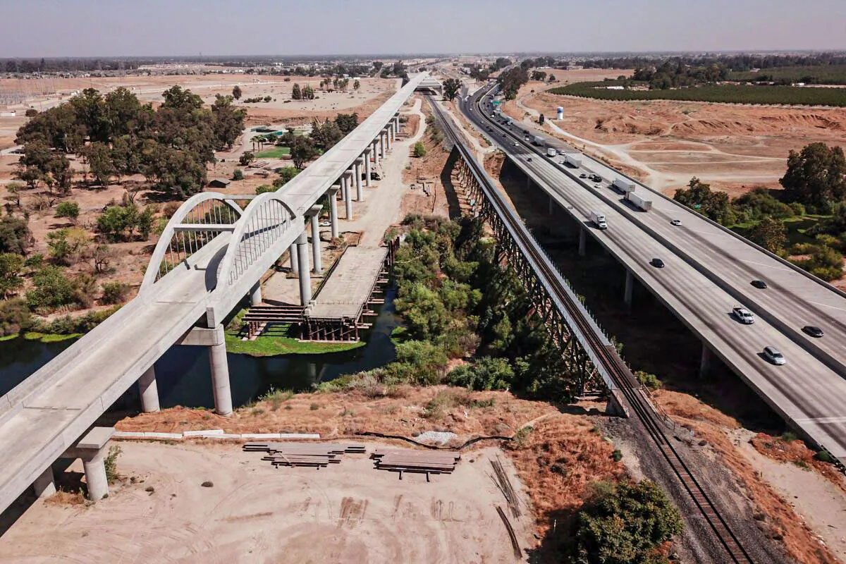 Vehicles drive past part of the California High-Speed Rail Authority San Joaquin River viaduct construction project alongside U.S. Highway 99 in California on Aug. 26, 2021. (Patrick T. Fallon/AFP via Getty Images)