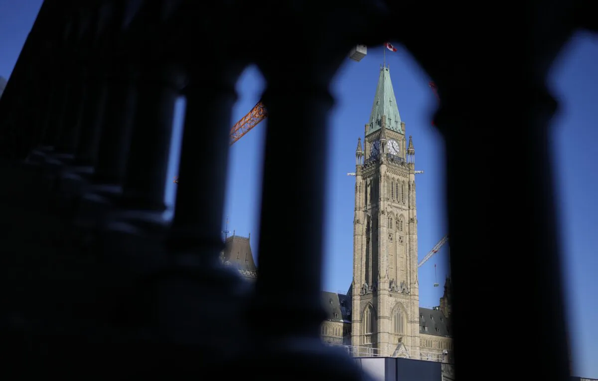 The Peace Tower on Parliament Hill in Ottawa is framed in a railing, on Jan. 24, 2025. (The Canadian Press/Adrian Wyld)