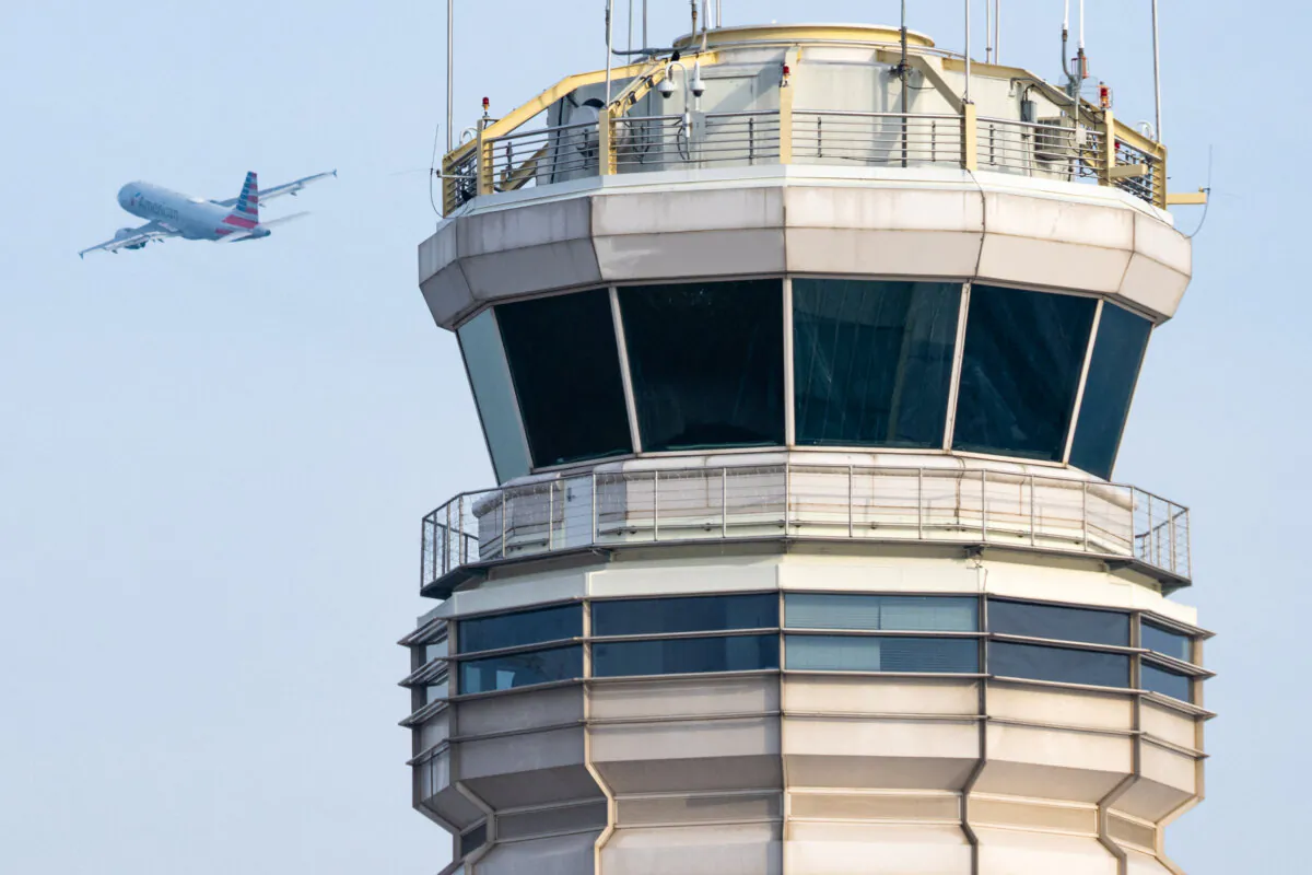 An American Airlines airplane takes off past the air traffic control tower at Ronald Reagan Washington National Airport in Arlington, Va., on Jan. 11, 2023. (Saul Loeb/AFP via Getty Images)