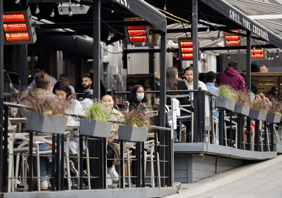 People dine in a restaurant in Montreal on May 30, 2021. (Graham Hughes/The Canadian Press)