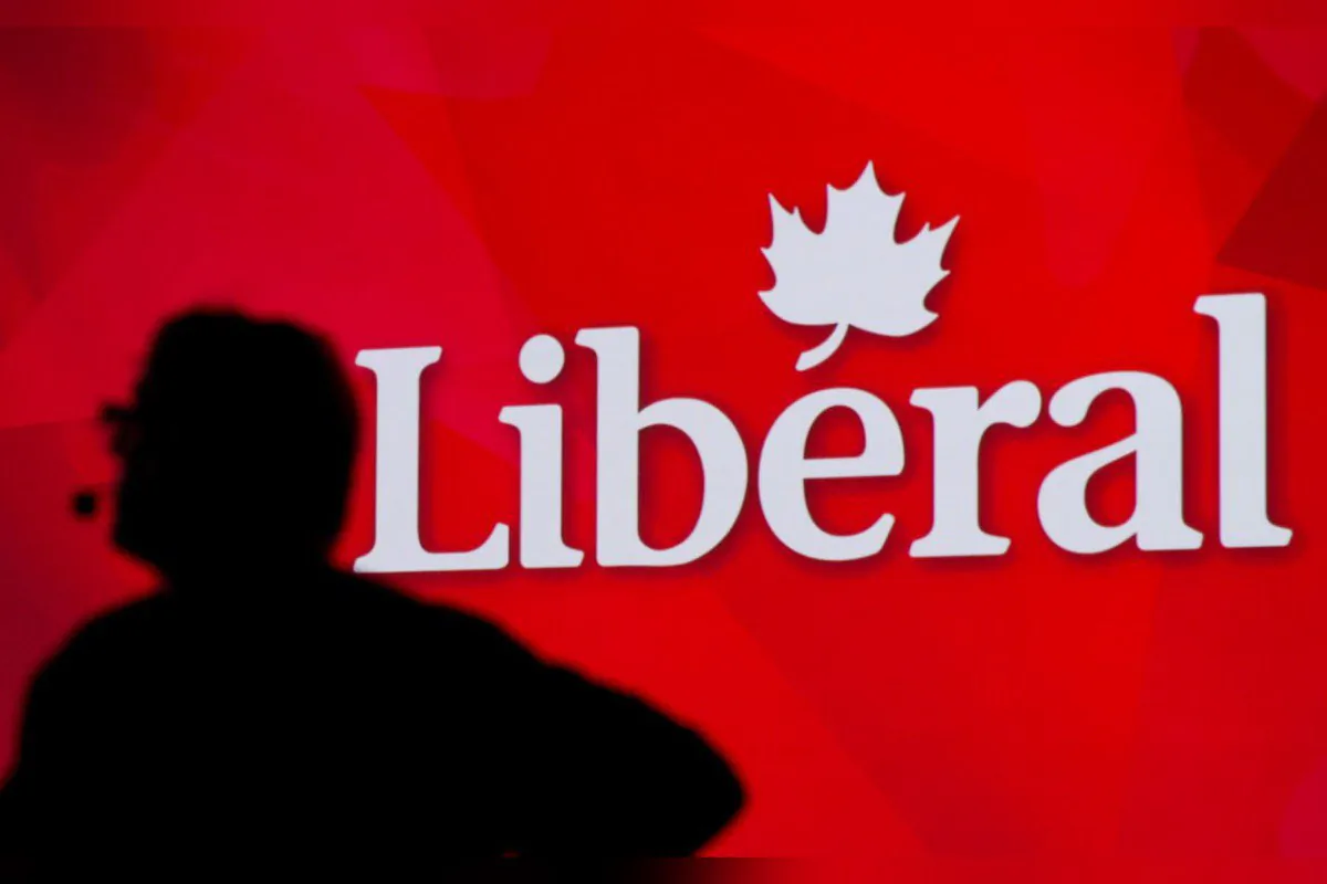 A Liberal Party of Canada logo is shown on a giant screen as a technician looks on during day one of the party's biennial convention in Montreal on Feb. 20, 2014. (The Canadian Press/Graham Hughes)