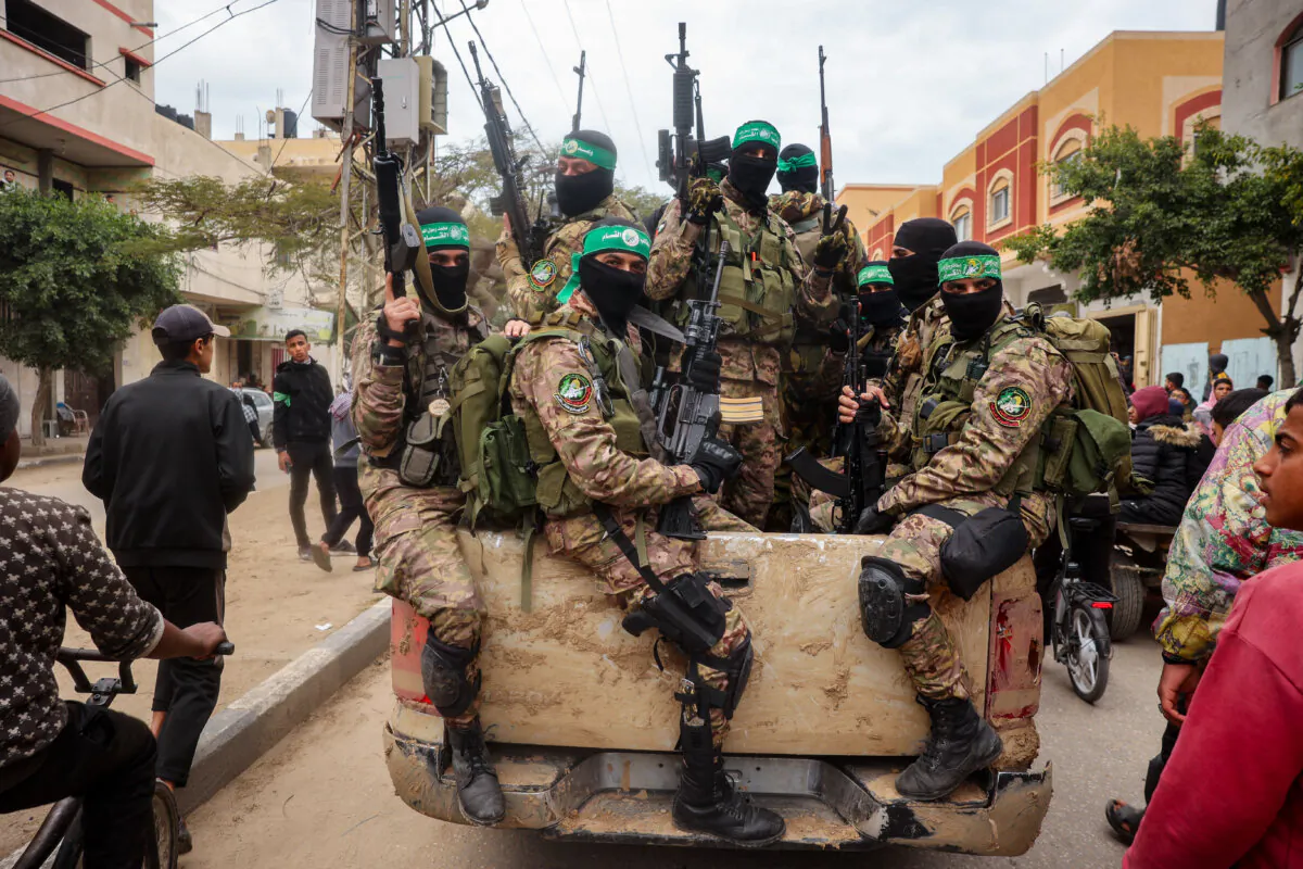 Hamas fighters on patrol before handing over three Israeli hostages to a Red Cross team in Deir al-Balah, central Gaza, on Feb. 8, 2025. (Eyad Baba/AFP via Getty Images)
