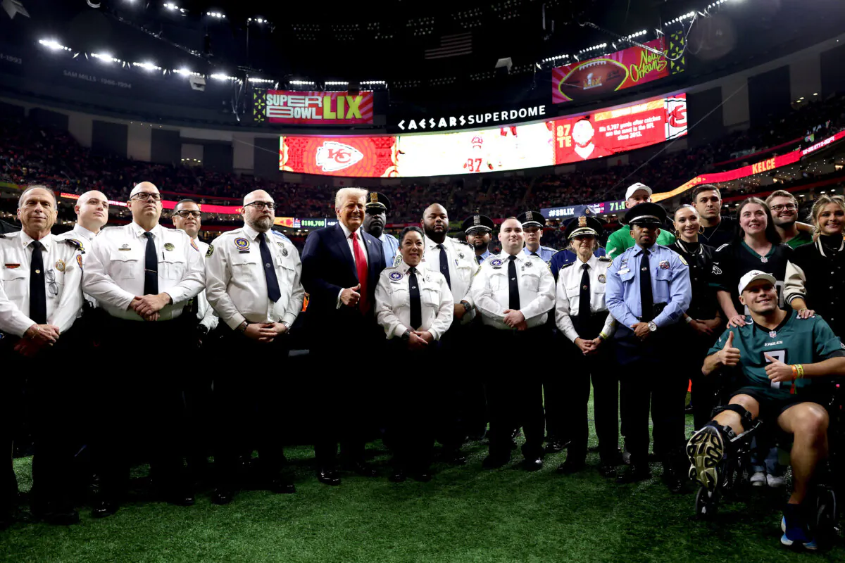 President Donald Trump poses with family members of victims in the Jan. 1 attack on Bourbon Street and emergency responders prior to Super Bowl LIX between the Kansas City Chiefs and the Philadelphia Eagles at Caesars Superdome in New Orleans on Feb. 9, 2025. (Jamie Squire/Getty Images)