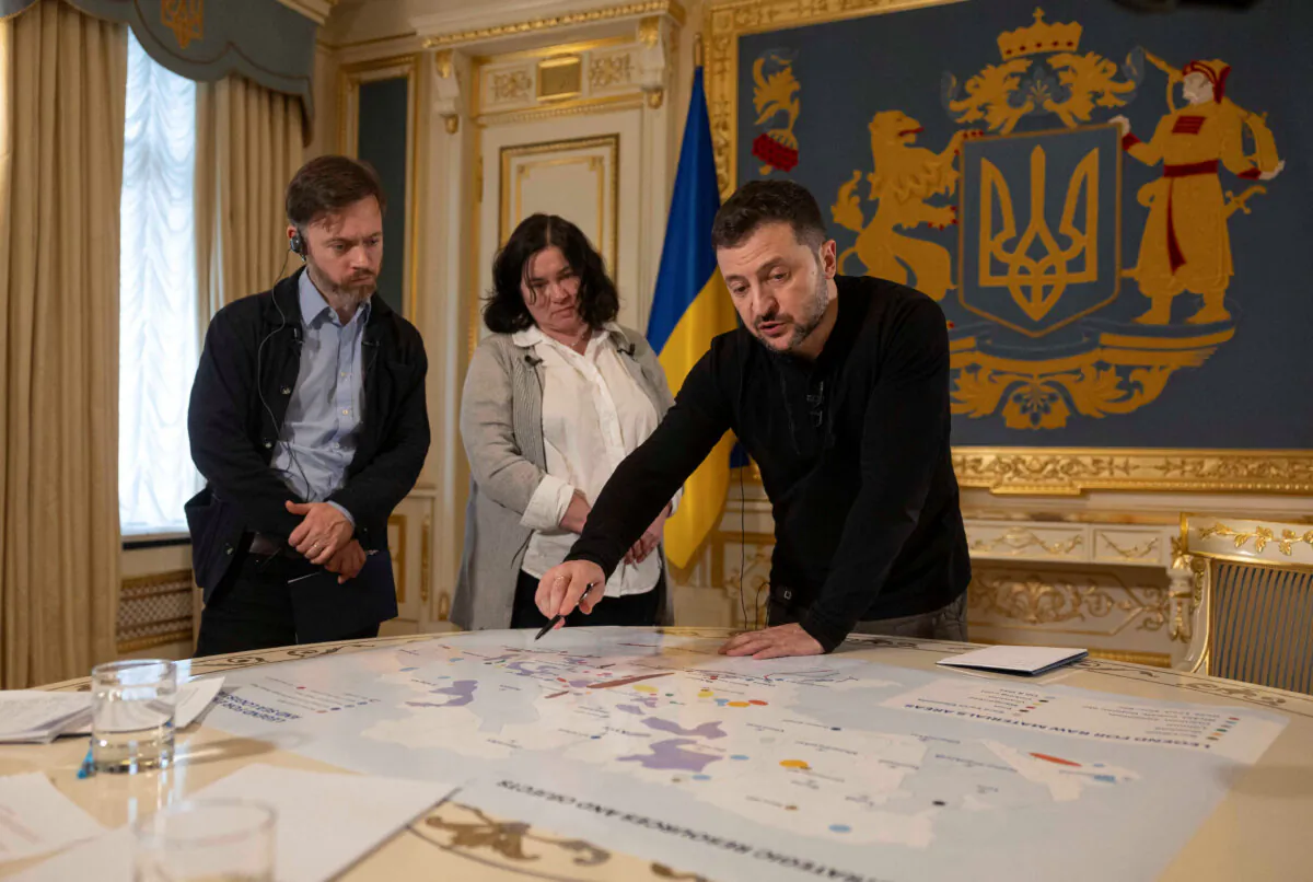 Ukrainian President Volodymyr Zelenskyy shows Reuters journalists a map of strategic resources at his presidential office in Kyiv, Ukraine, on Feb. 7, 2025. (Valentyn Ogirenko/Reuters)
