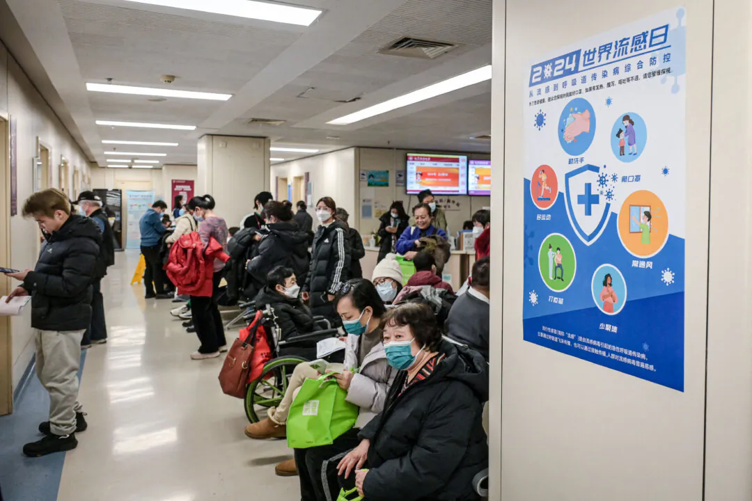 People wear masks as they wait at an outpatient area of the respiratory department of a hospital in Beijing on Jan. 8, 2025. (Jade Gao/AFP via Getty Images)