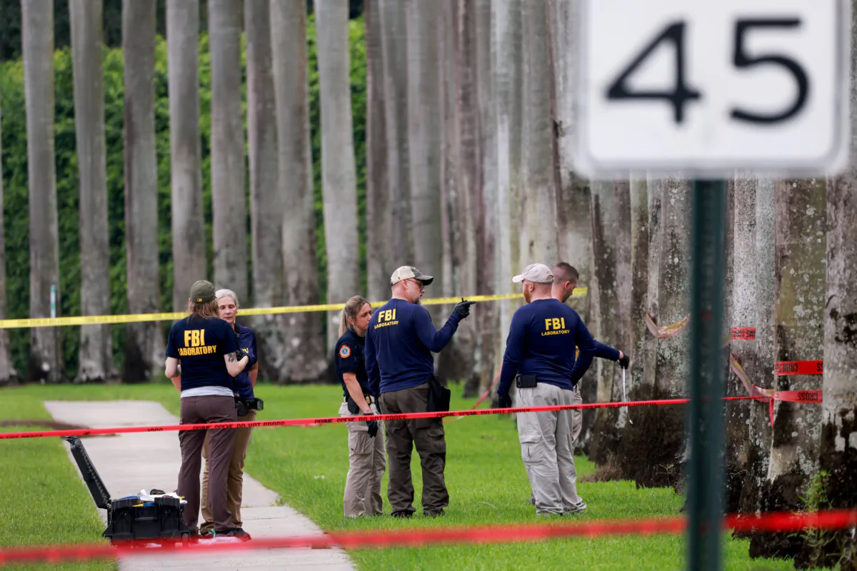 Law enforcement personnel continue to investigate the area where the Secret Service discovered a would-be assassin of President Donald Trump at the Trump International Golf Club in West Palm Beach, Fla., on Sept. 17, 2024. (Joe Raedle/Getty Images)