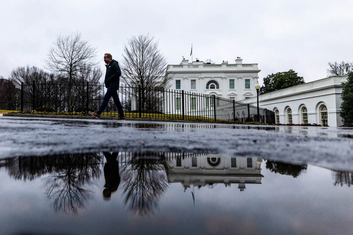 A reporter leaves the White House after the daily briefing, in Washington, on Jan. 31, 2025. (Carlos Barria/Reuters)