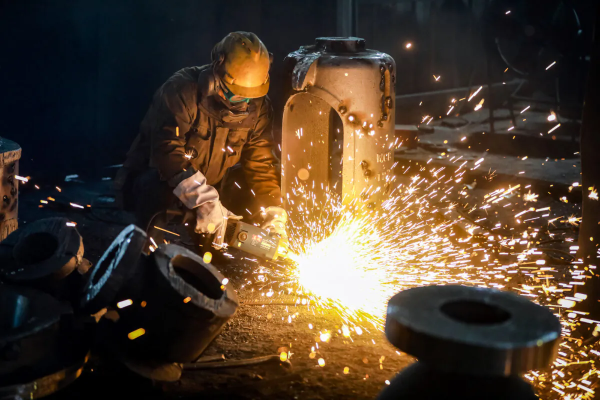 An employee works on steel casting at a factory in Hangzhou, Zhejiang Province, China, on Jan. 17, 2024. (STR/AFP via Getty Images)