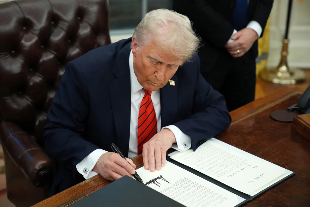 U.S. President Donald Trump signs a series of executive orders in the Oval Office at the White House in Washington on Feb. 10, 2025. (Andrew Harnik/Getty Images)