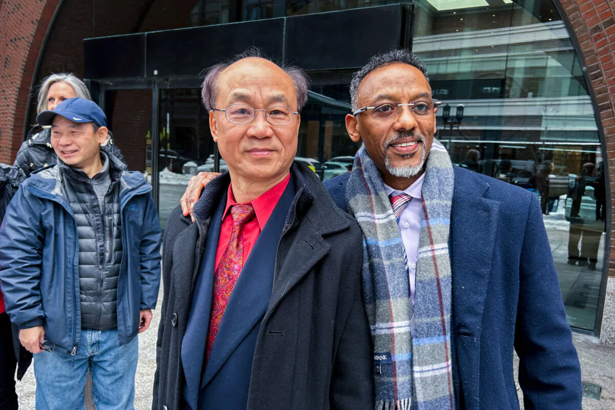 Massachusetts resident Litang Liang and his lawyer, Derege Demissie, stand outside the federal court after a jury acquitted Liang of U.S. charges that he acted as an unregistered agent of China, in Boston, Mass., on Feb. 10, 2025. (Nate Raymond/Reuters)