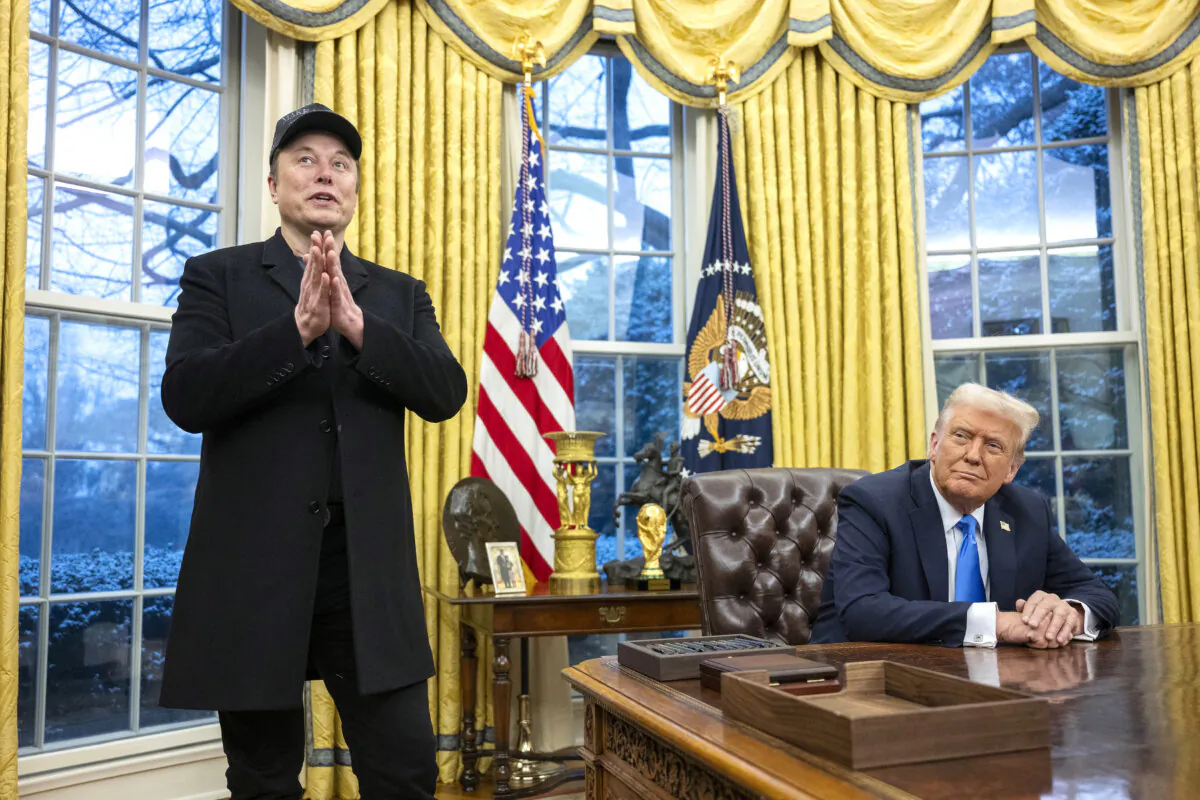 Elon Musk speaks as President Donald Trump looks on in the Oval Office of the White House on Feb. 11, 2025. (Jim Watson/AFP via Getty Images)