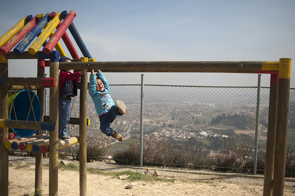 Children have fun at the playground of a school opened by the United Nations Refugee Agency in the Altos de Florida shantytown on the outskirts of Bogota on Nov. 2, 2012. (AFP PHOTO/Eitan Abramovich)
