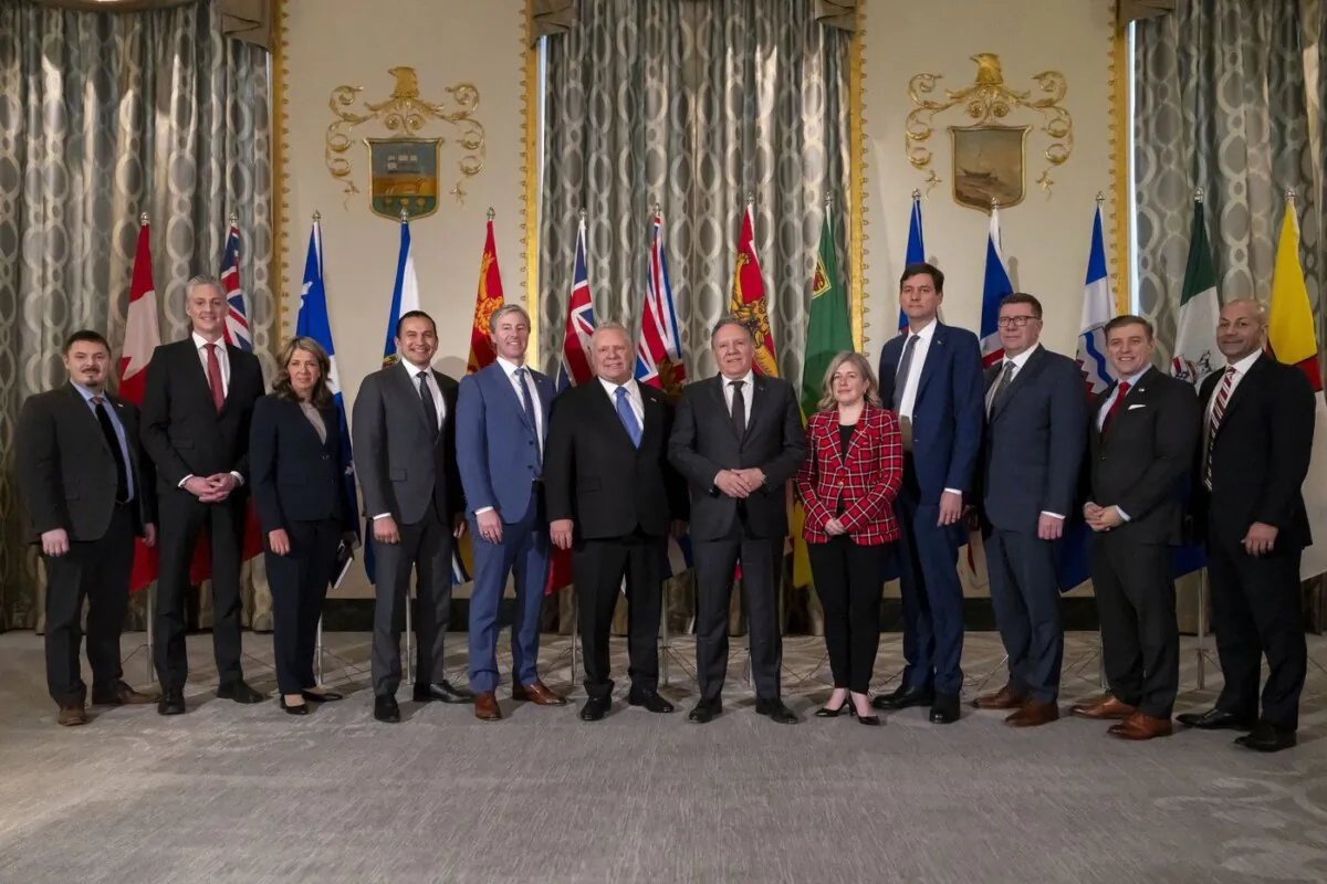 Twelve of Canada's premiers pose for a photograph before speaking to reporters at the Mayflower Hotel in Washington, Feb. 12, 2025. PEI Premier Dennis King left early because of snowstorm forecasts at home. (Ben Curtis/The Associated Press)