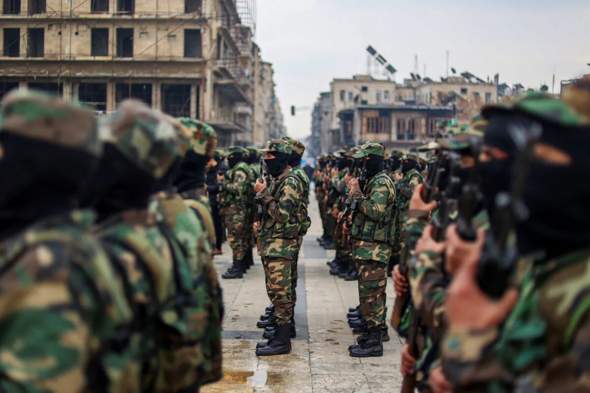 Graduates of Syria's General Security forces under the country's new administration attend a ceremony in the northern city of Aleppo on February 12, 2025.  (Photo by Aaref Watad/AFP via Getty Images.) 