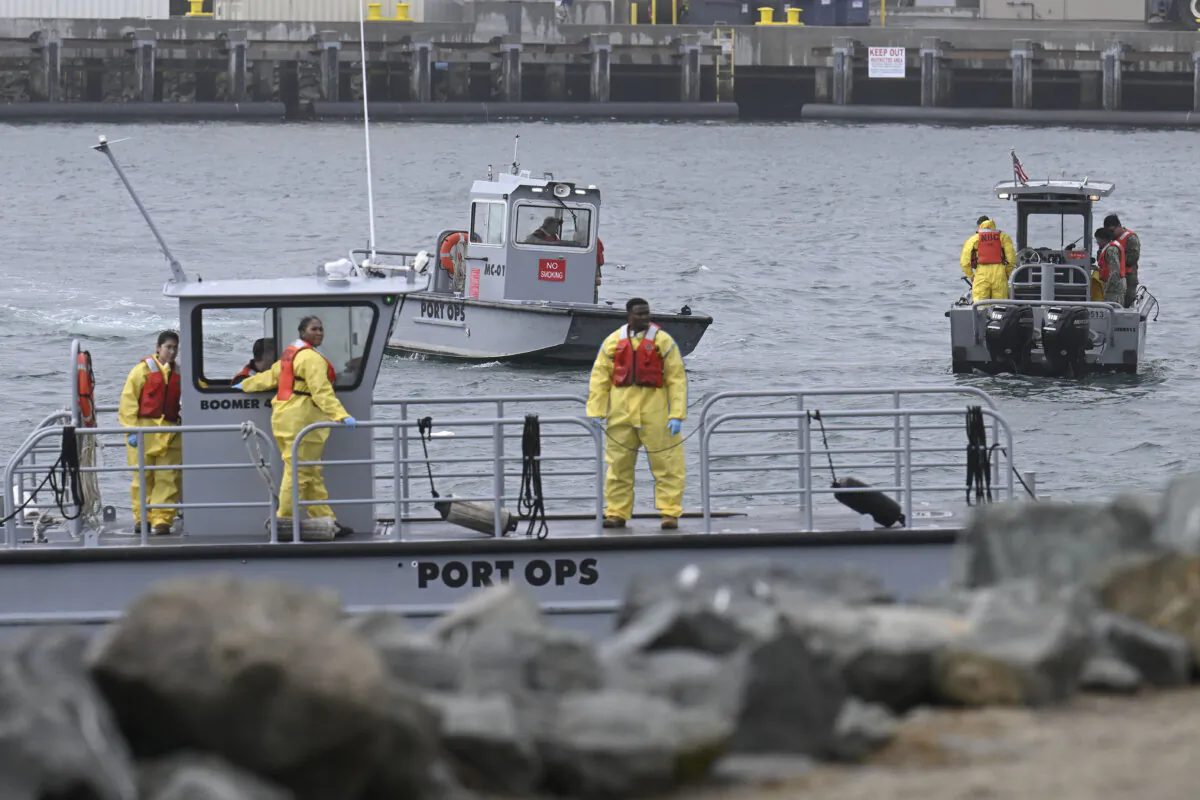 U.S. Navy boats work along the shore near Shelter Island after a U.S. Navy plane crashed into the San Diego Bay in San Diego on Feb. 12, 2025. (Denis Poroy/AP Photo)