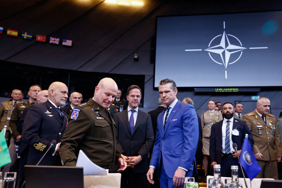 NATO Secretary-General Mark Rutte (C) and U.S. Defense Secretary Pete Hegseth (center R) react prior to the start of The NATO Ministers of Defence meeting at NATO Headquarters in Brussels, on Feb. 13, 2025. (SIMON WOHLFAHRT/AFP via Getty Images)